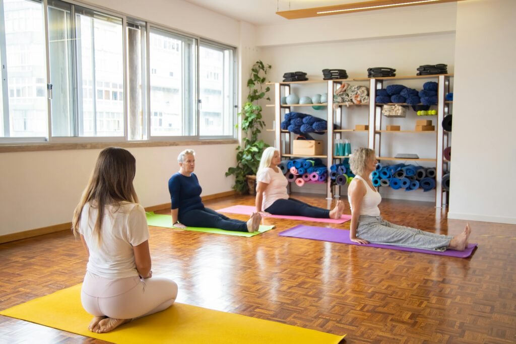pexels-photo-5992885-5992885 A diverse group of senior women practicing yoga indoors with mats.